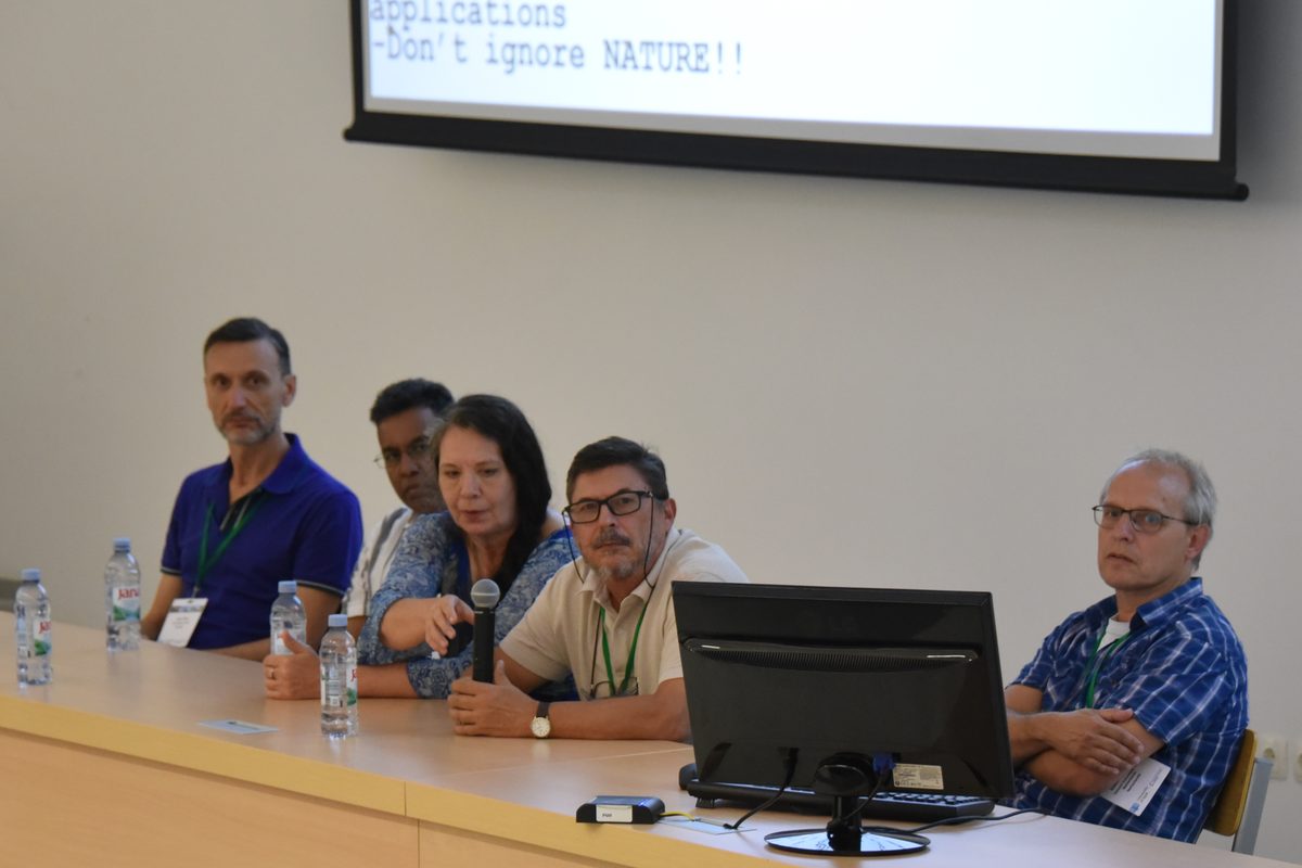 Five panellists seated at a long table during the closing panel at IMAP 2026, with Dr. Inanç Birol at the far left and a slide reading "Don&rsquo;t ignore NATURE!!" on the screen behind them